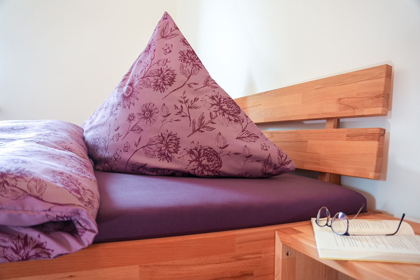 Holzdoppeltbett mit Kaltschaummatratzen und frischer Bettwäsche zum Ausruhen